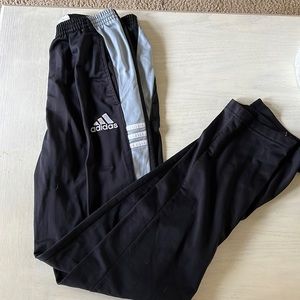 Adidas black and grey sweatpants with pockets and zippers at ankle